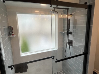 Hexagon shower tiles, glass shower door, modern shower design, frosted window idea, elegant bathroom inspiration