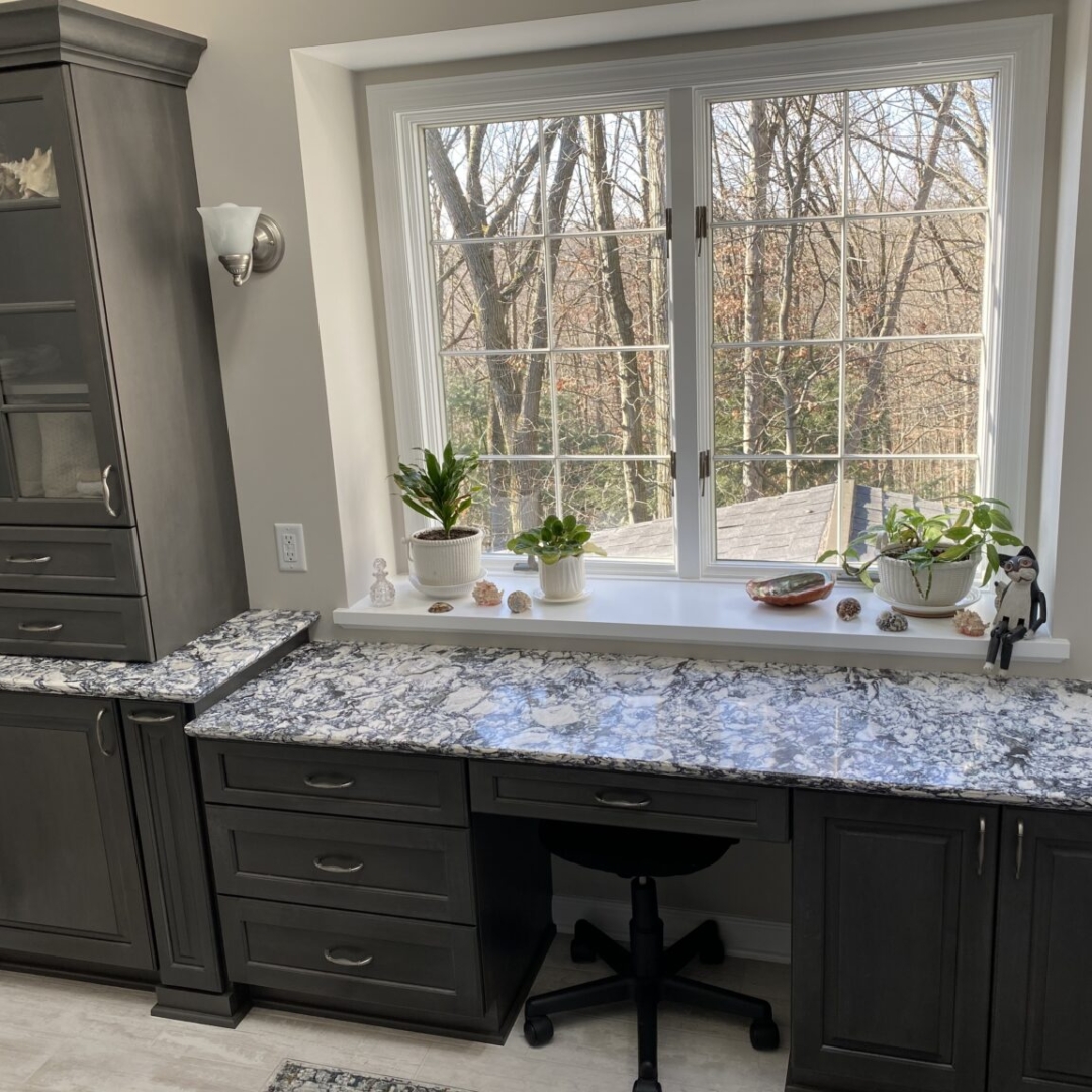 Classic marble counter bathroom, black and white countertop, dark cabinet shelves, big window
