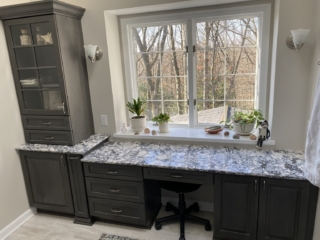 Classic marble counter bathroom, black and white countertop, dark cabinet shelves, big window